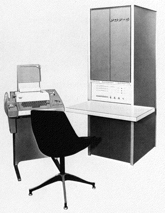 photo of 6-foot high rack-mounted computer with teletype and chair