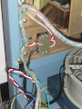 photo of power wiring harness with part of the spiral wrap in the process of being re-wrapped around added wires