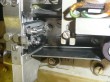 thumbnail photo of a complex mechanism, the tape guide does not align with the punch block because it is a bit too long